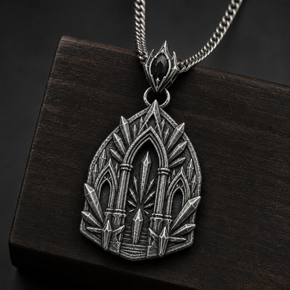 Oxidized 925 sterling silver pendant necklace with a sacred arch temple relief, raised shard-like silver details, round connector and curb chain on a black background.
