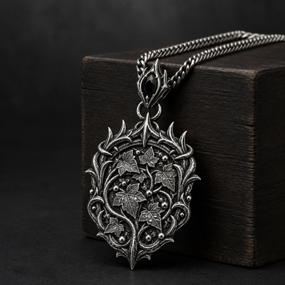 Oxidized 925 sterling silver pendant necklace with an elven thorn crown frame, raised ivy leaves and bead-like dew details on an included curb chain.