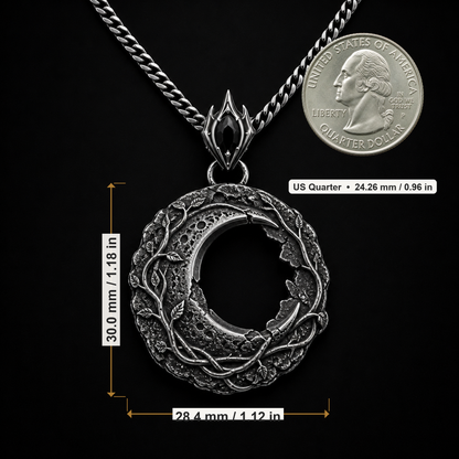 Oxidized 925 sterling silver hollow moon pendant with raised vine details, crater-like texture, ornate bail and included curb chain on a black background.