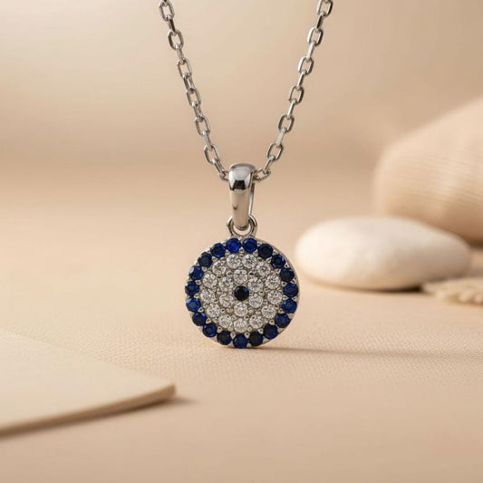 Silver-finish Blue Halo Evil Eye Necklace close-up showing the blue outer ring and tapered bail