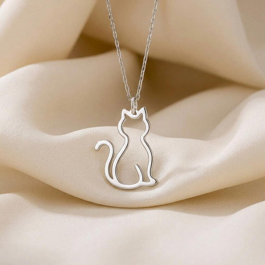 Cat Outline Necklace pendant displayed on draped ivory fabric