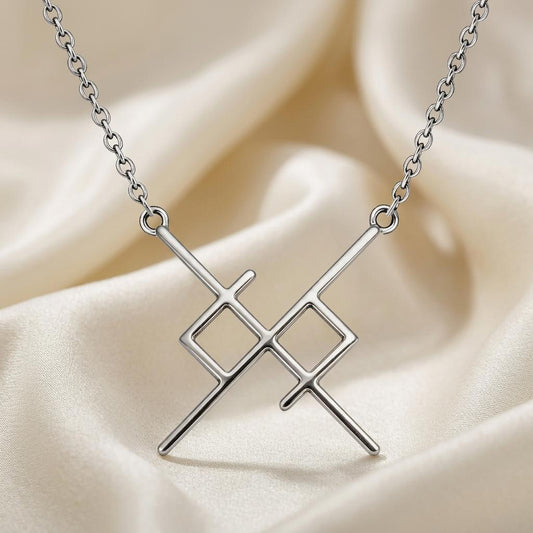 Silver Soul Bond Rune Necklace with crossed bars and two open diamond shapes on ivory satin